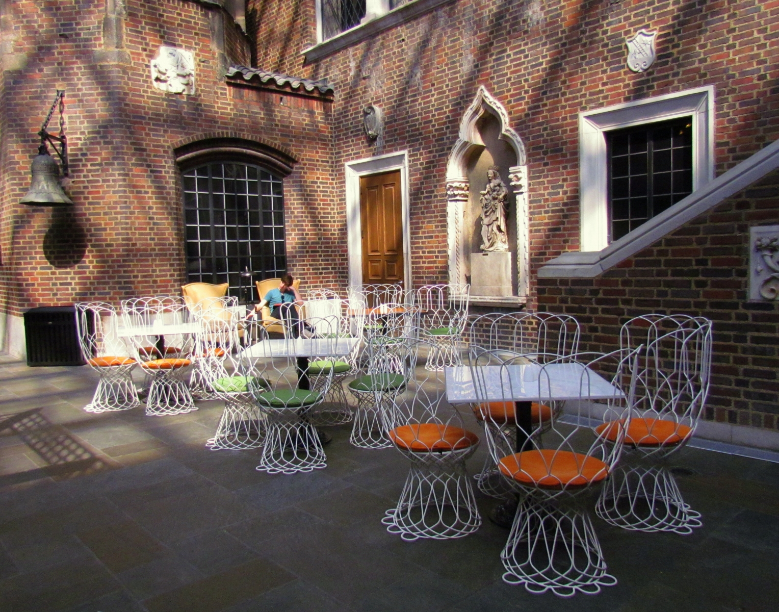 an outdoor terrace featuring tables and chairs